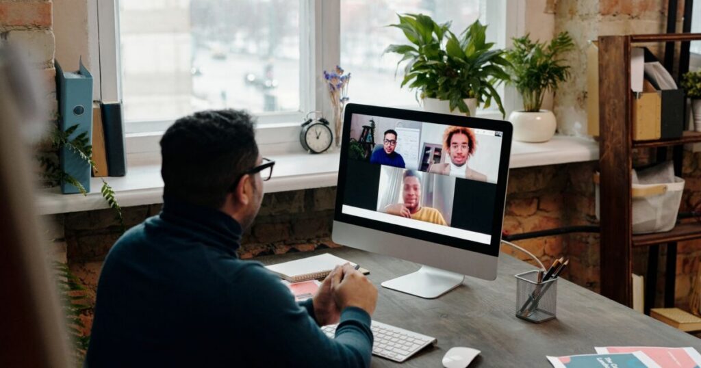 Manager on a video call with a distributed team, weighing Oyster HR alternatives