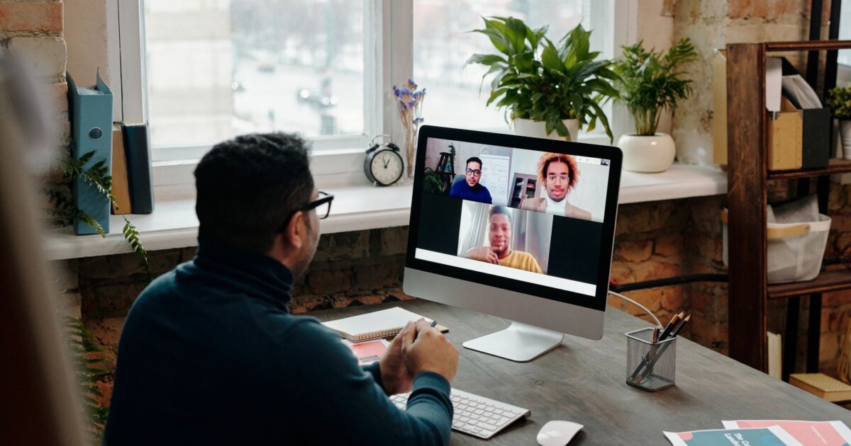 Manager on a video call with a distributed team, weighing Oyster HR alternatives